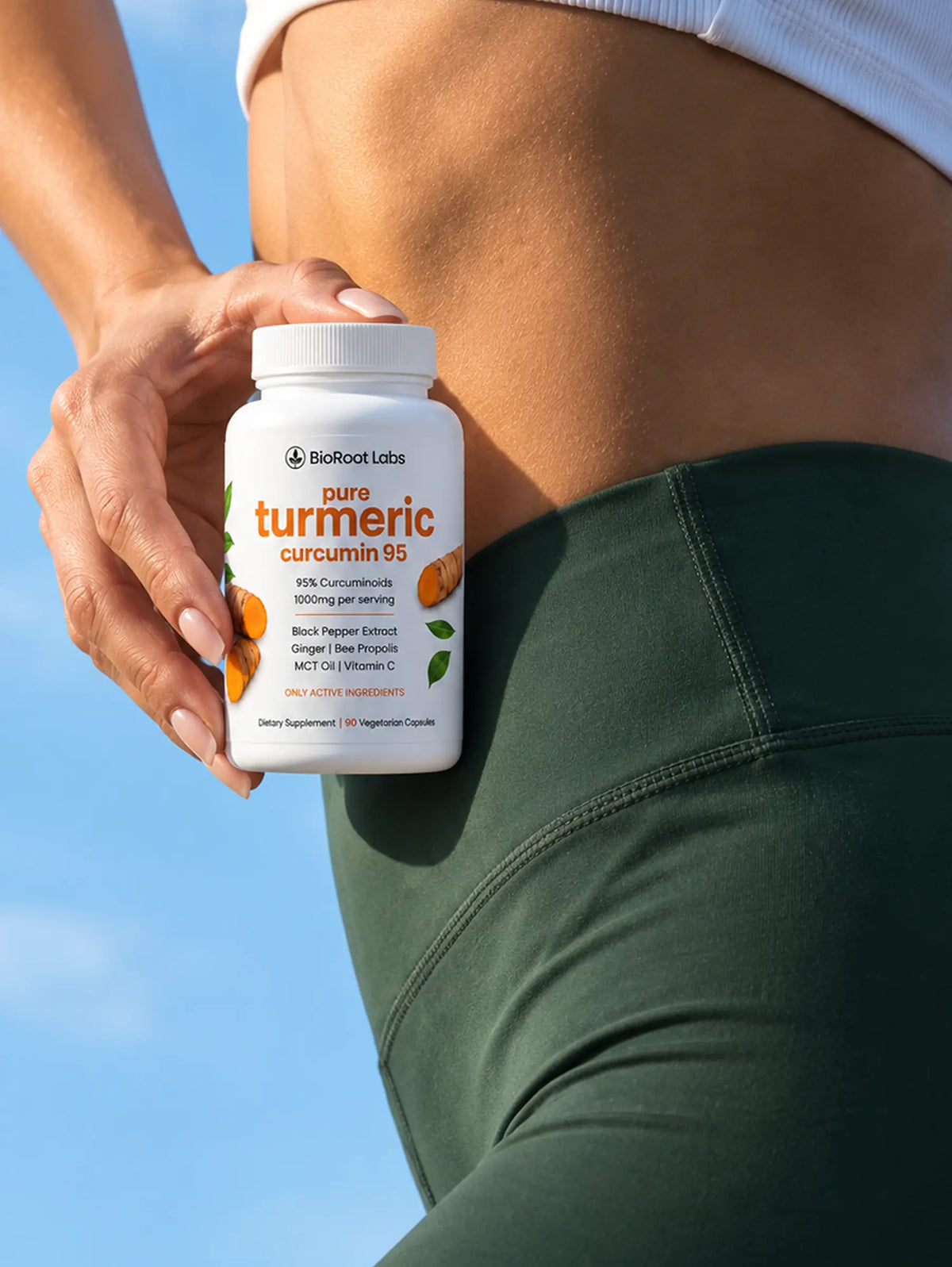 Woman holding a bottle of BioRoot Pure Turmeric Curcumin 95